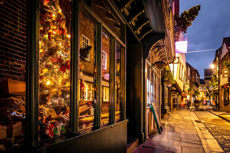 York at Christmas, with decorations & lights in the Shambles, a historic shopping street in the city centre, York, Yorkshire, UK