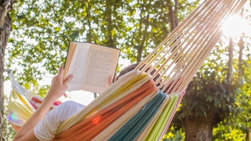 reading at dusk in the hammock with the open book