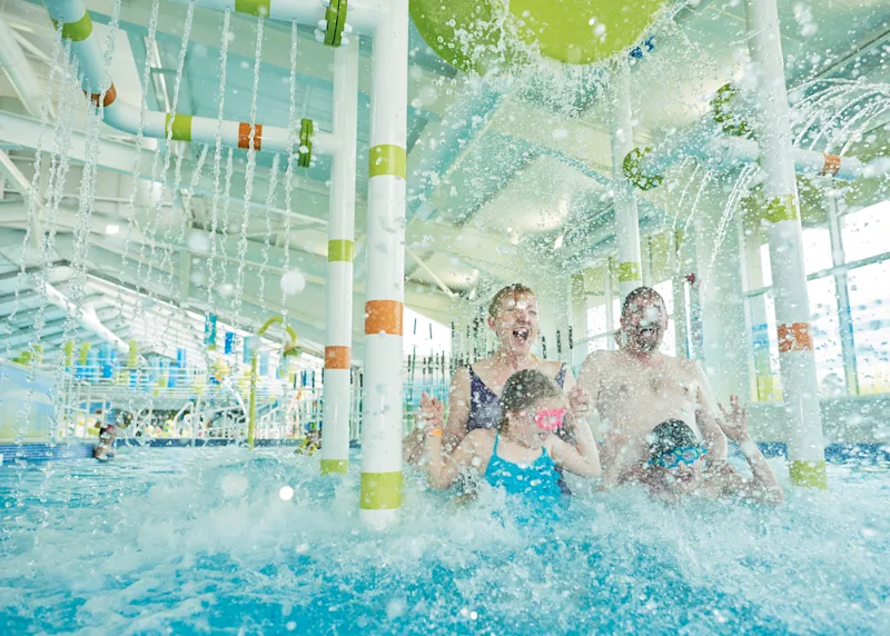 Family having fun in the indoor swimming pool at Thornwick Bay (THOR) in Flamborough, Yorkshire Moors and Coast, England, UK