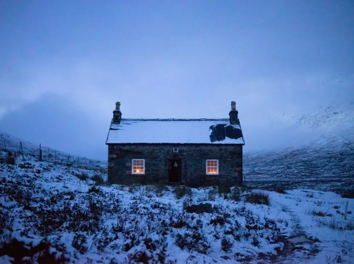 House covered with snow on a misty day
