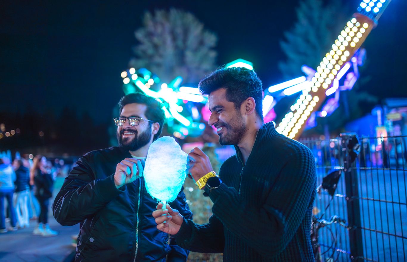 Two men eating cotton candy