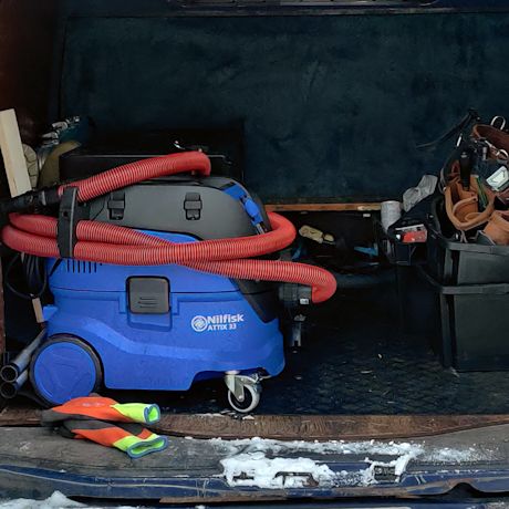 Nilfisk märkä-kuivaimuri matkalla työmaalle pakettiautossa