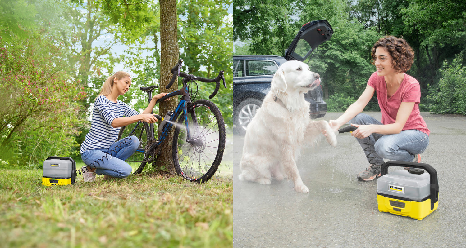 Nainen pesee puun vieressä sinisen maastopyörän ja koiraa keltaisella painepesurilla.