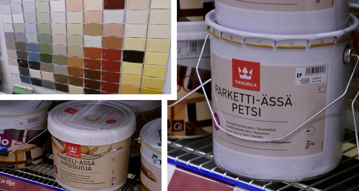 Monivärinen sävykartanäyttö ja hyllyssä Tikkurila-paneeli- sekä parkettipetsipurkkeja.