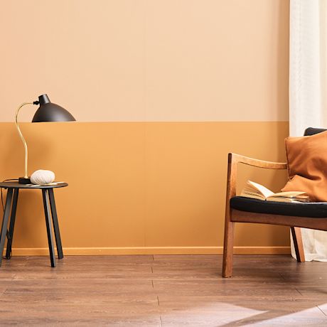 Oranssiksi maalattu sisätilan seinä, kaksi eri sävyä
