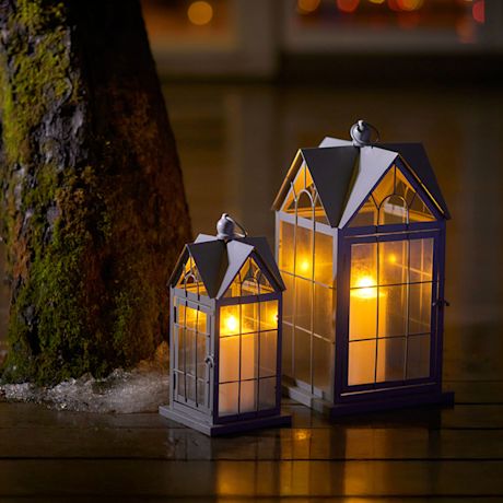 Kuvassa kaksi talon mallista lyhtyä.