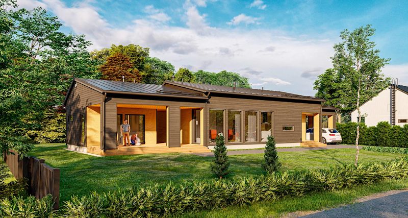 Moderni tumma puurunkoinen talo, terassilla isä ja lapsi, vihreä piha ja puita.