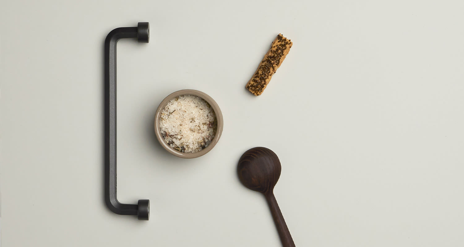 Cello-keittiö moodboard, jossa musta vedin ja keittiötarvikkeita.