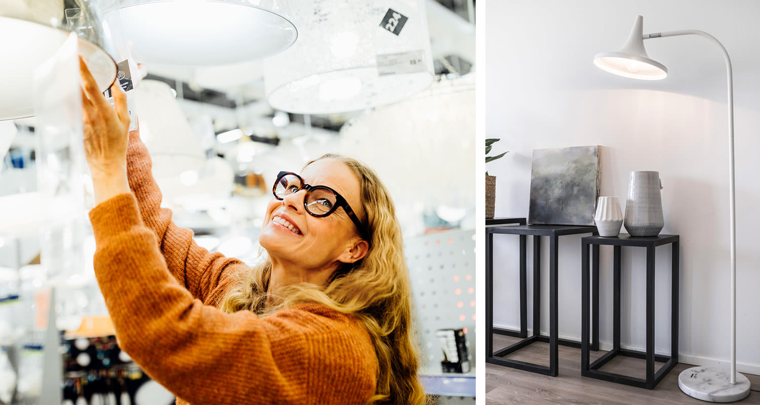 Asiakas valitsee valkoista lamppua myymälässä; lattiavalaisin ja mustat sivupöydät maljakoineen