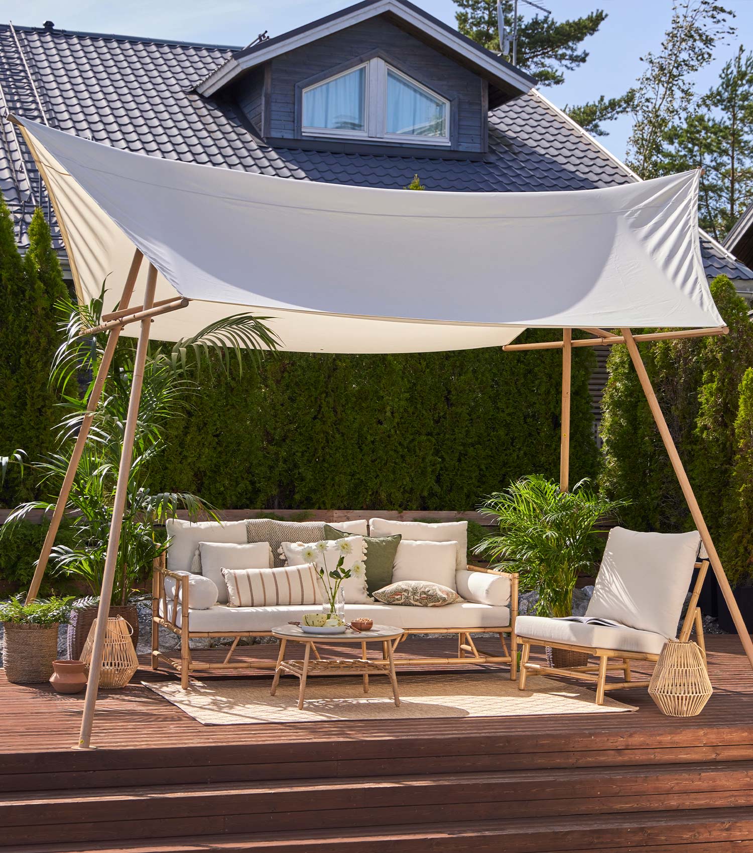 Terassi sisustettu K-Raudan Cello-terassikaluisteilla. Kuvassa sohva, pöytä, nojatuoli sekä pehmusteita.