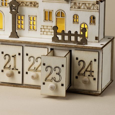 Kuvassa vanerinen joulukalenteri johon saa valot.