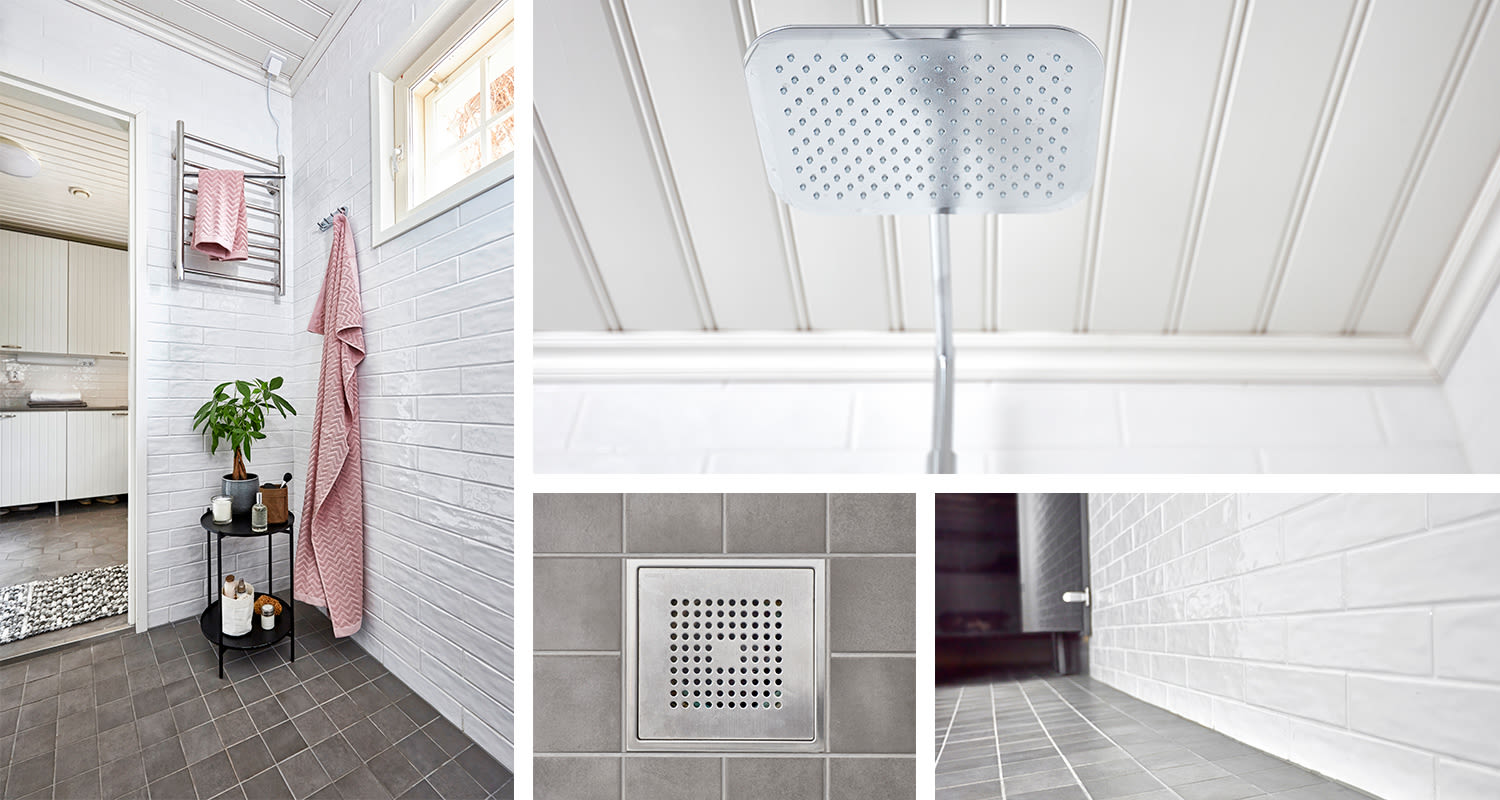 Moderni valkotiilinen kylpyhuone harmaalla laattalattialla, vaaleanpunaiset pyyhkeet, neliösuihku.