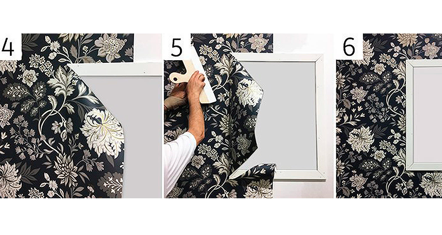 Miehen kädet silottamassa musta-beige kukkahenkistä tapettia valkoisen kehyksen ympärillä