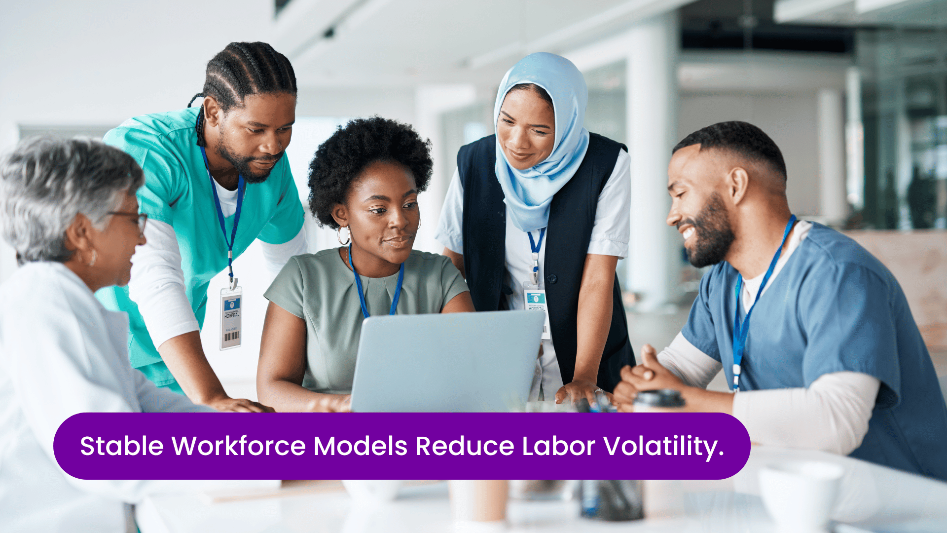 Hospital HR leader reviewing workforce data with nurses gathered around a desk, illustrating stable nurse staffing models, labor cost control, workforce planning, and strategies to reduce healthcare labor volatility