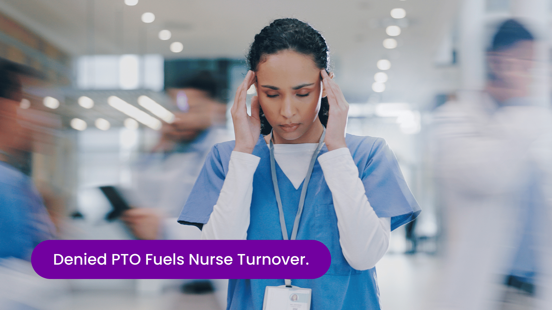 Stressed nurse standing in a busy hospital hallway with hands on her head, illustrating nurse burnout, denied PTO, workforce strain, and rising nurse turnover risk in healthcare systems.