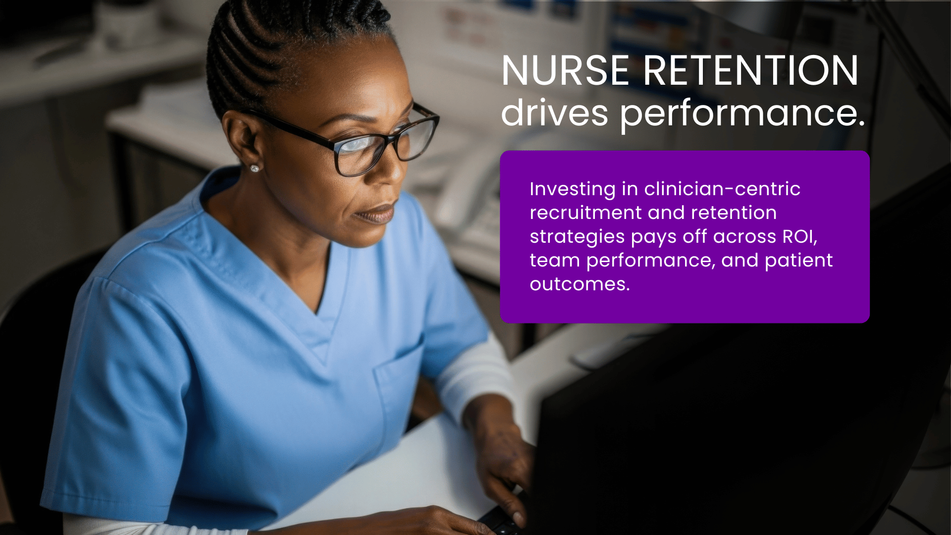 A nurse sitting at a hospital nurses station reviewing a computer, illustrating how clinician-centric recruitment and retention strategies drive performance and address healthcare recruitment challenges.