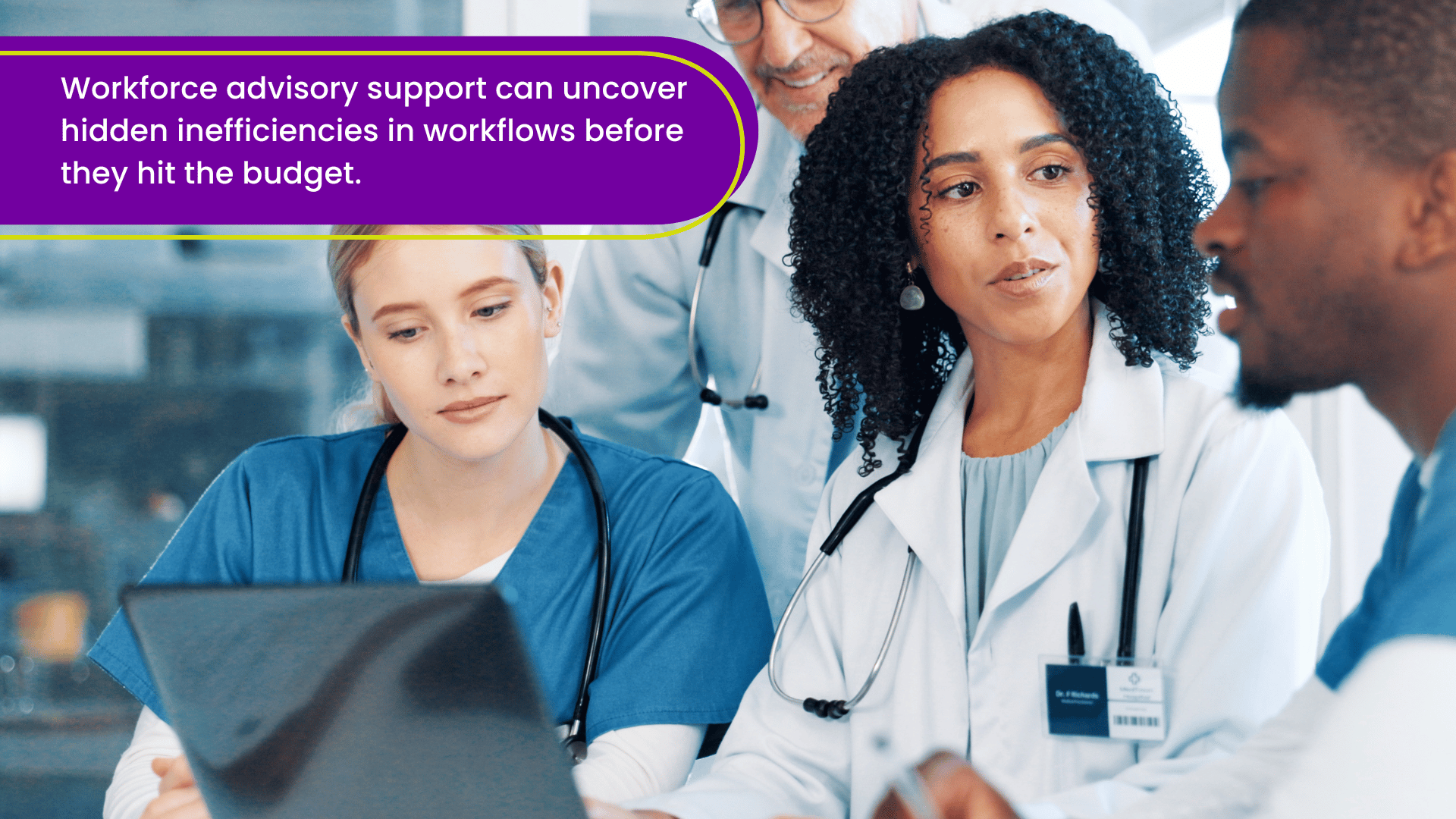 Healthcare leadership team analyzing workforce data on a laptop to identify staffing efficiencies and optimize clinical workflows.