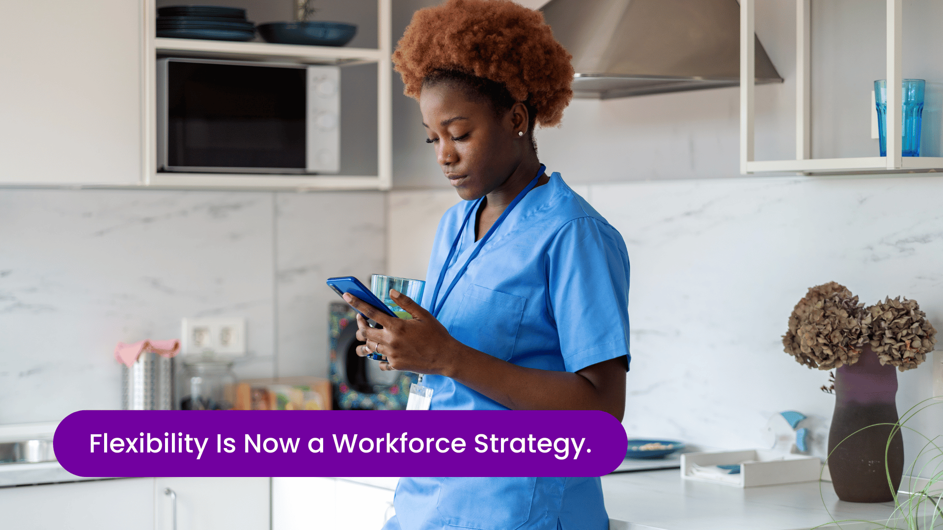 Nurse at home reviewing available shifts on her phone, representing flexible nurse staffing models, on-demand workforce solutions, and modern healthcare workforce strategy.