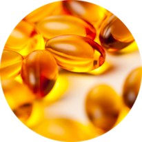 Close-up of several golden fish oil capsules scattered on a soft surface.