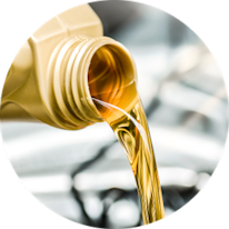 Oil being poured from a container into a vehicle engine.