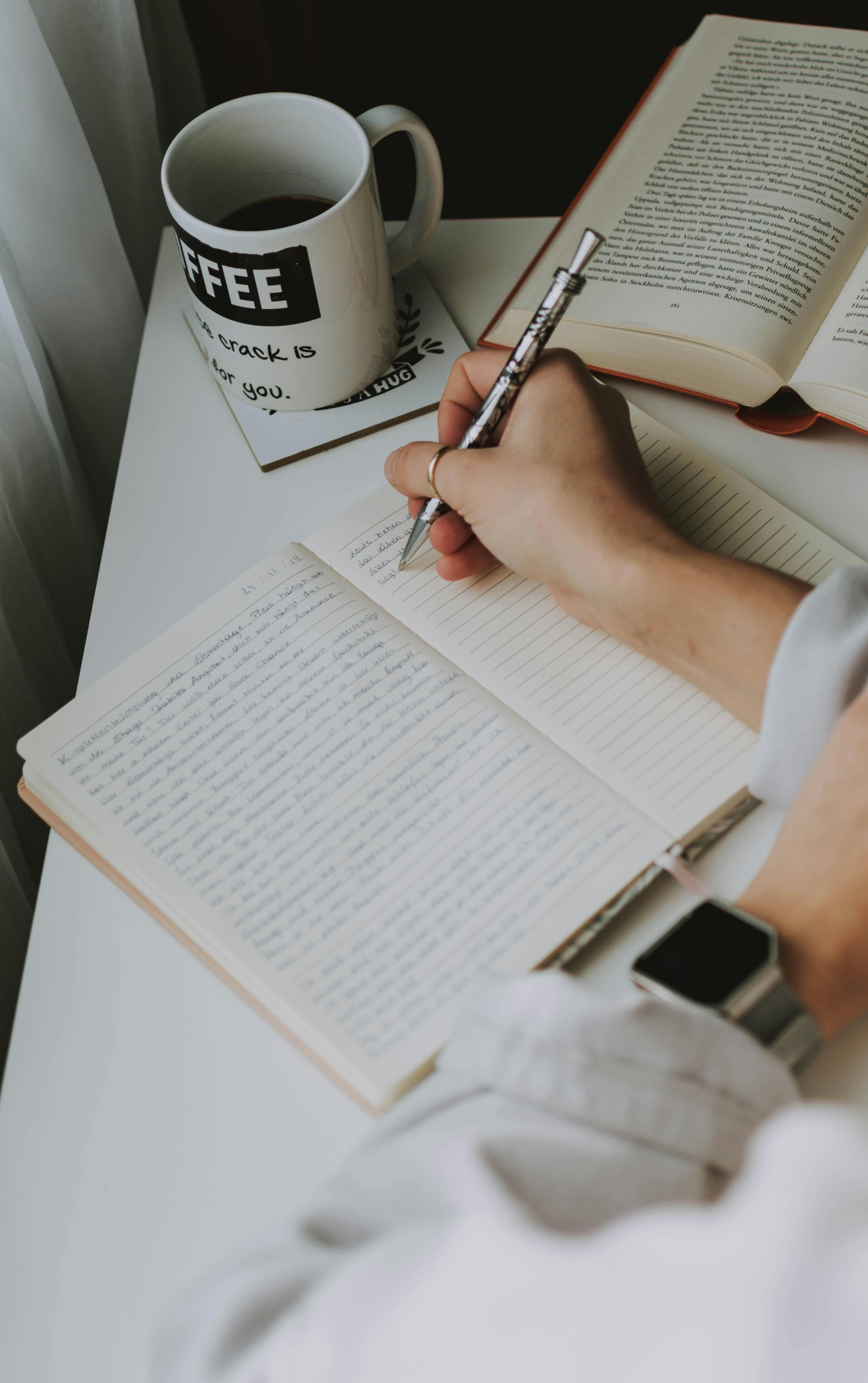 Free Person Writing on Notebook Stock Photo