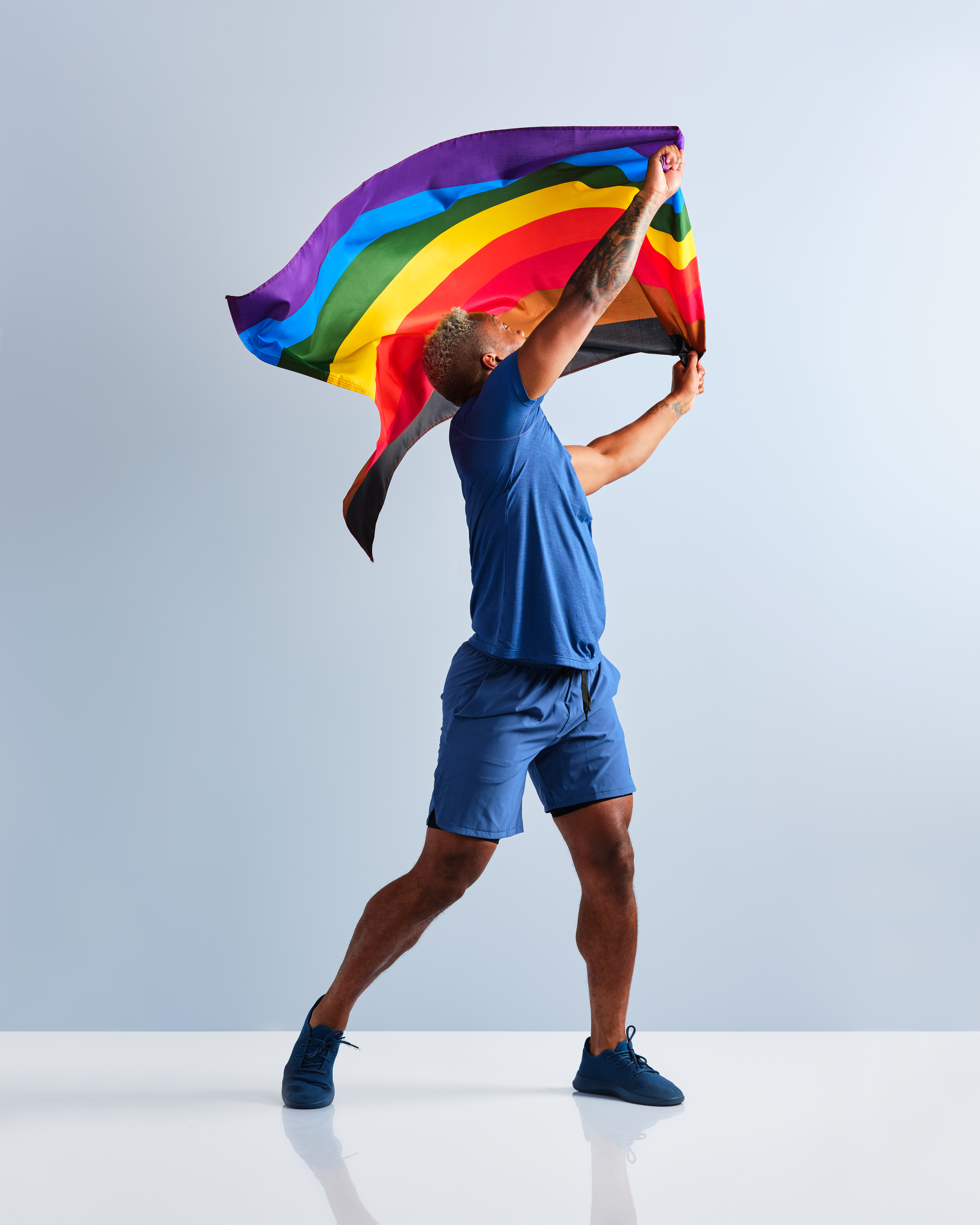 6.8Blog_CoachClarencewavingRainbowFlag