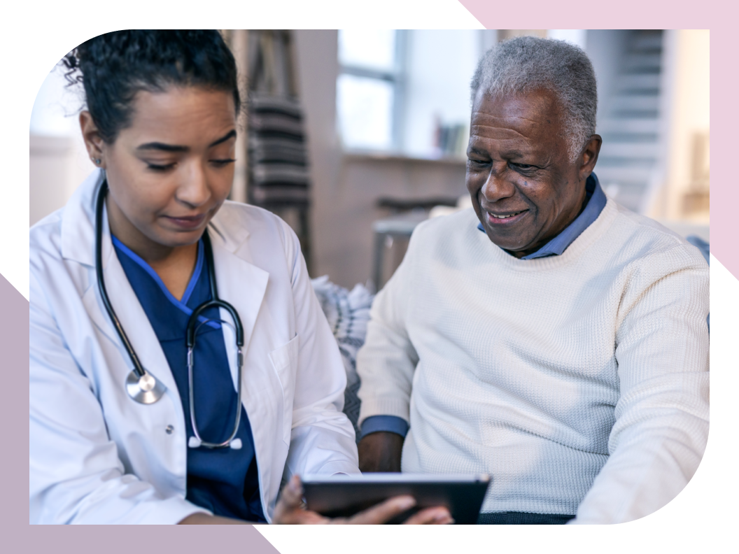 Care provider shows a digital tablet to an older resident
