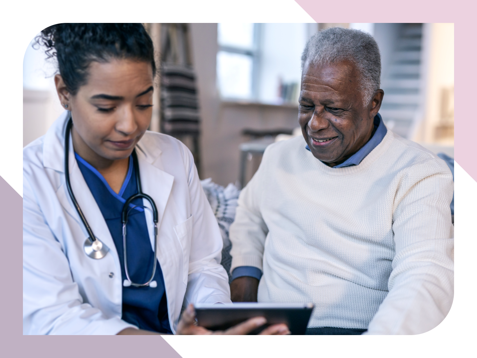 Care provider shows a digital tablet to an older resident