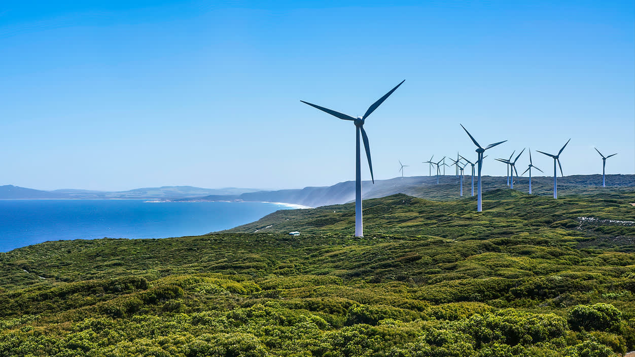 Wind turbines overlooking the coast on a sunny day