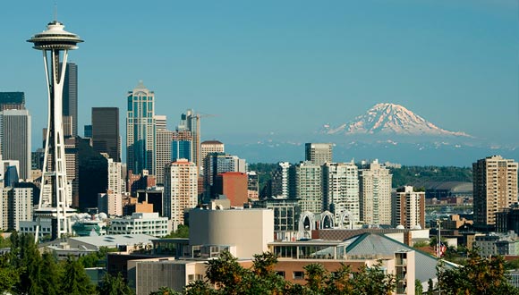 Visual urbano de Seattle com o Space Needle à esquerda e o Monte Rainier de fundo
