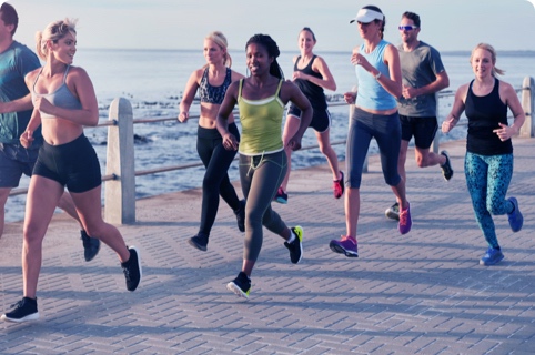 Group run on a boardwalk overlooking the ocean.