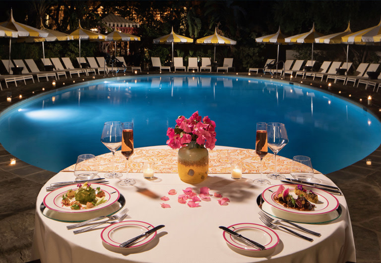 Picture of dining table by a pool, click to see offer details