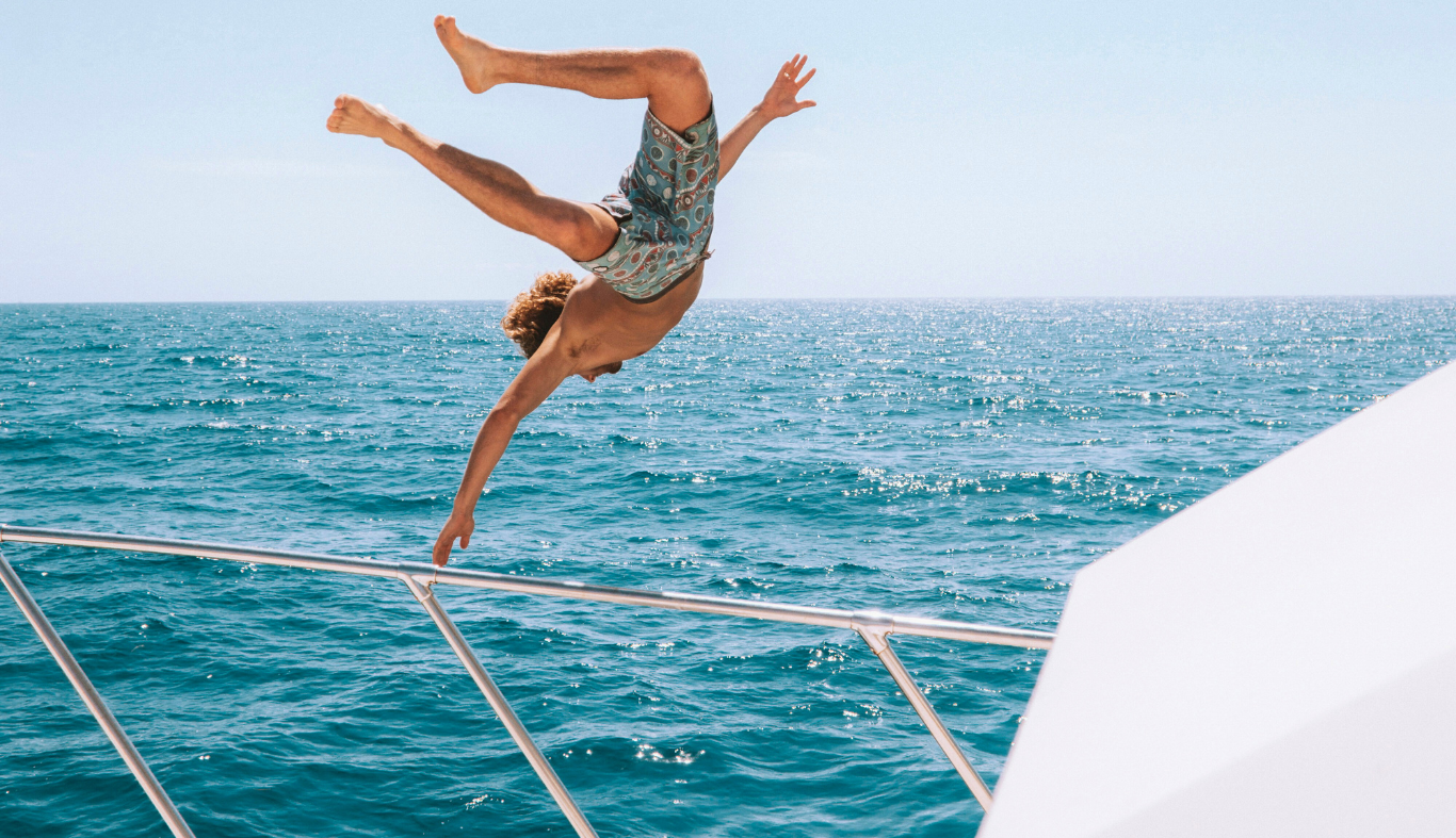 man-jumping-in-ocean-bahamas