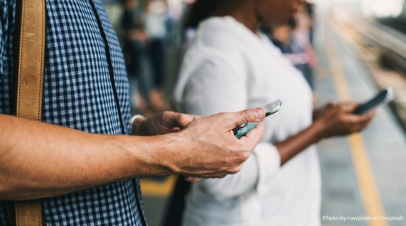 People looking down at phones