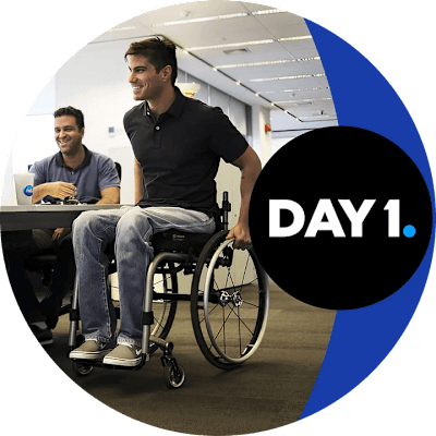 Person in a wheelchair in an office space with 'Day 1' text displayed.