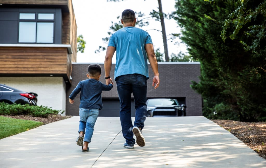 Man and Son in Front of House