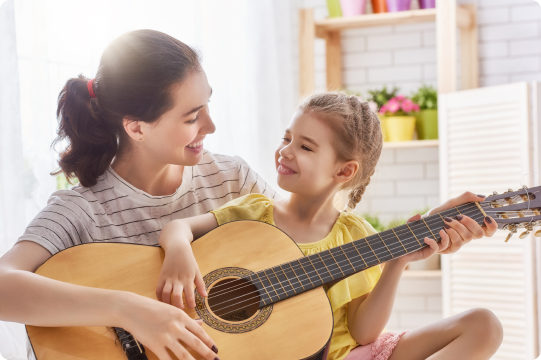 woman and child playing guitar