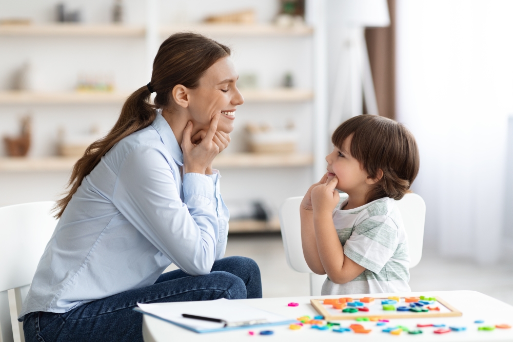 A speech-language pathologist working with a young child. 