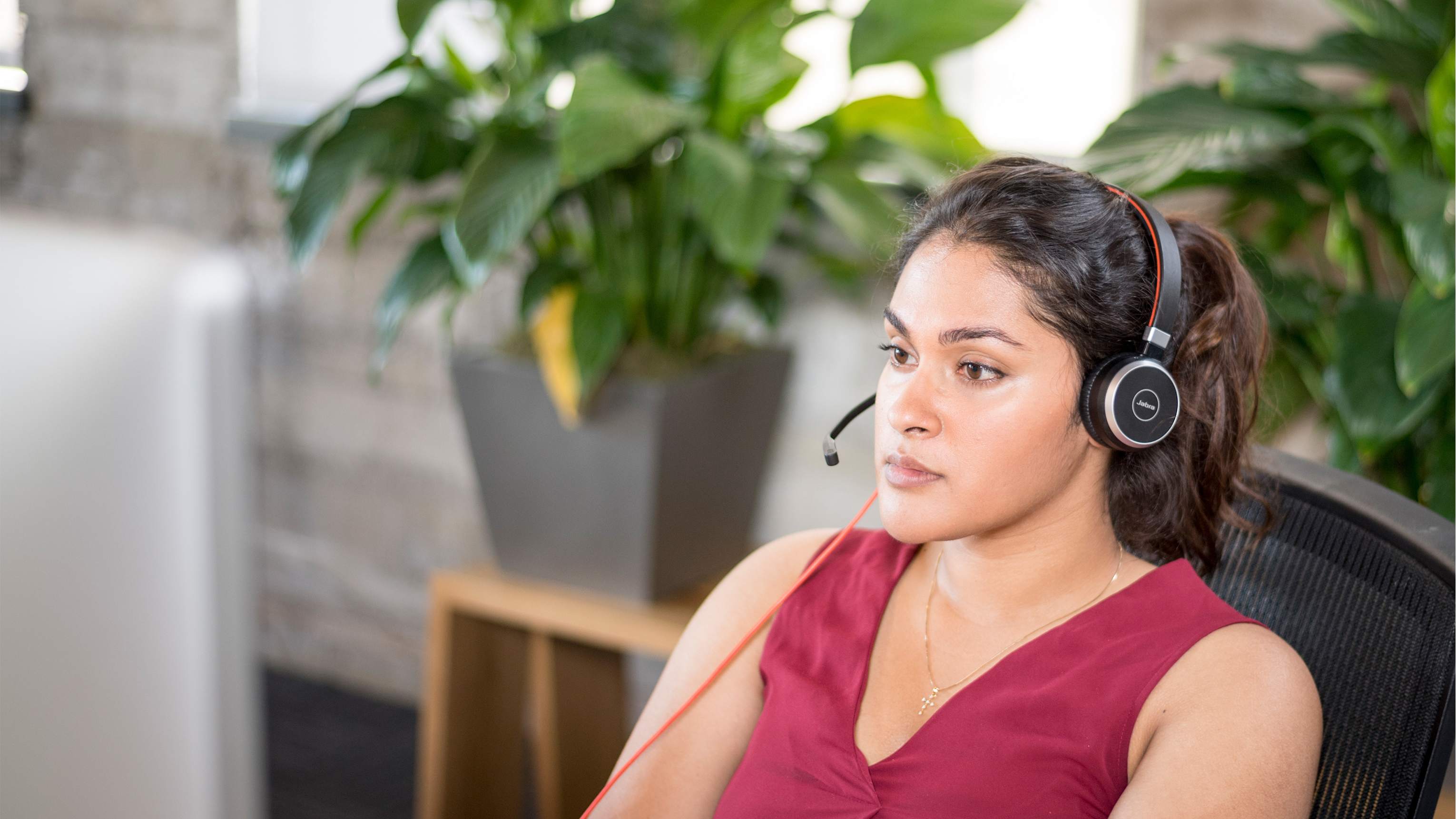 Female at desk with headset - hero image - Talk to an expert page