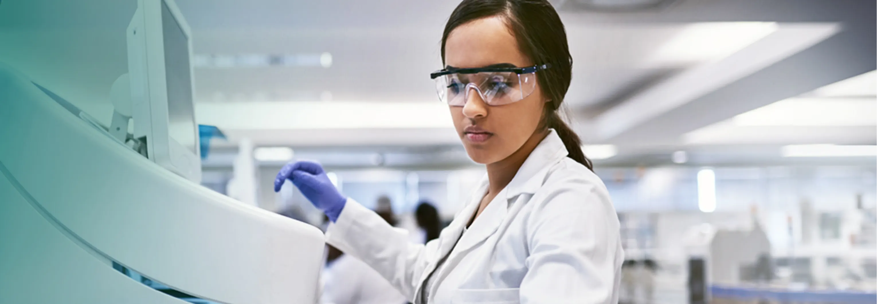 Clinician operating laboratory equipment - Invitae Generation genetic variant classification