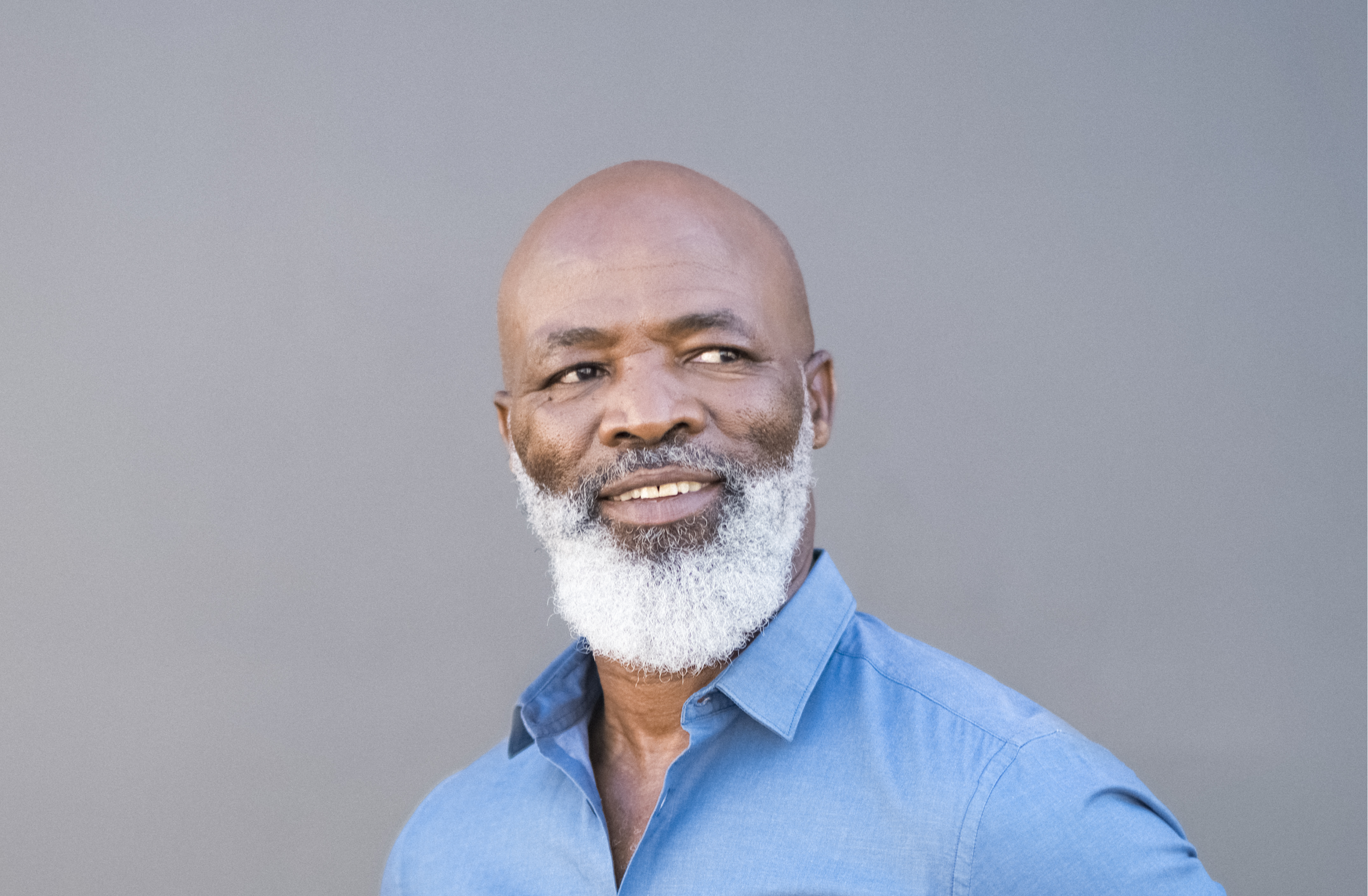 Middle aged black male bald with gray beard