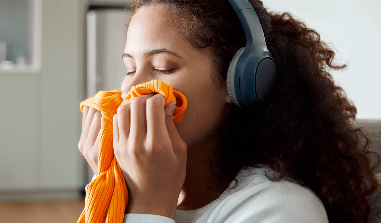 Woman smelling clothes