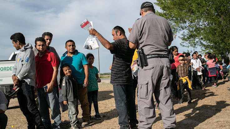 Immigrants are searched by border security.