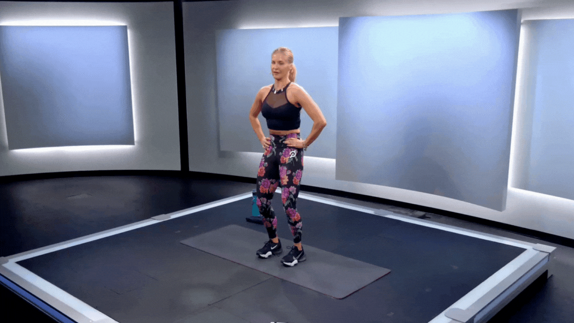 Peloton instructor Rebecca Kennedy demonstrates a standing pelvic tilt exercise to help with finding a neutral spine.