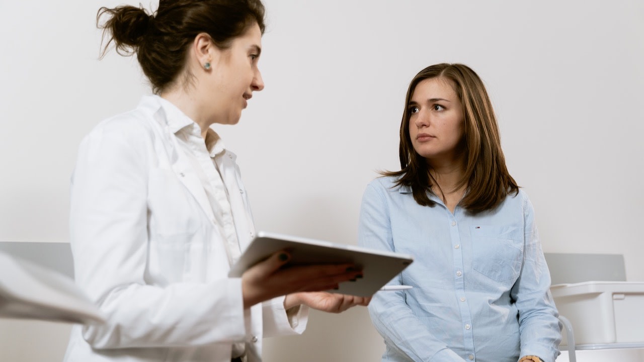 dokter praat met patiënt met een tablet in de hand empowerment van patienten