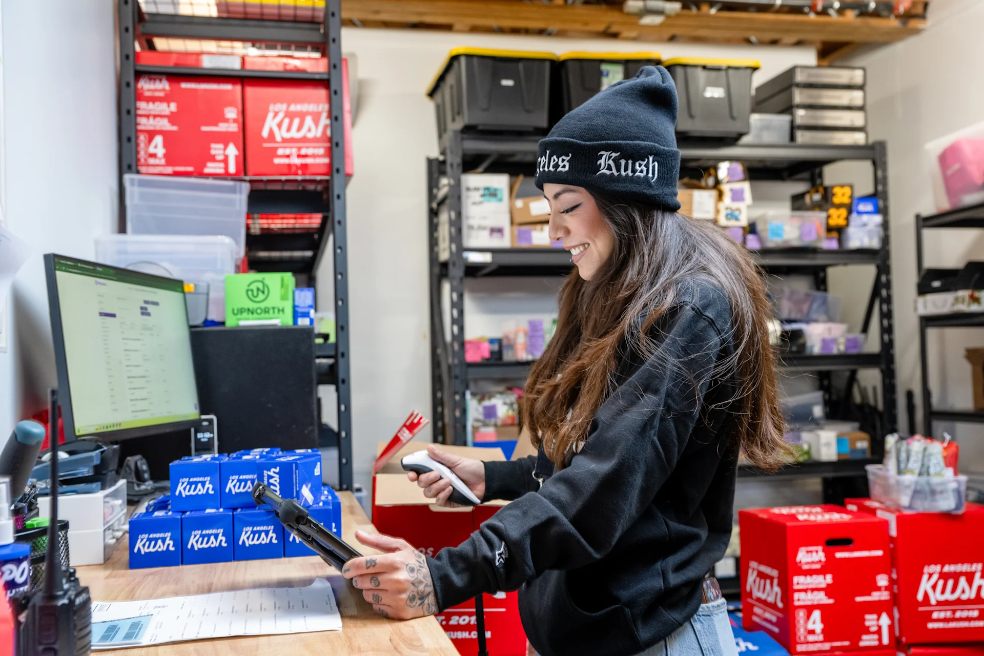 Dispensary employee scanning cannabis inventory barcodes with Meadow