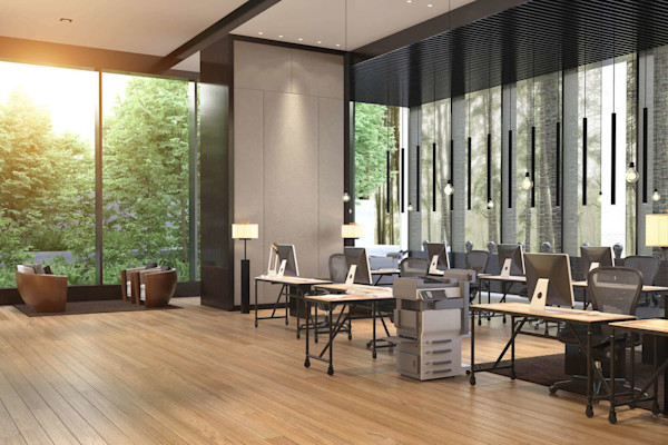 Bright coworking space with monitors, desks, and couch