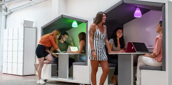 custom office design with a wall mounted sturage solution and custom employee meeting booths