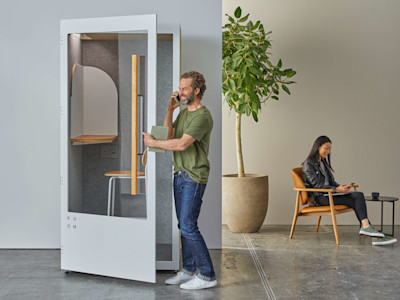 man on phone in acoustic office soundproof pod