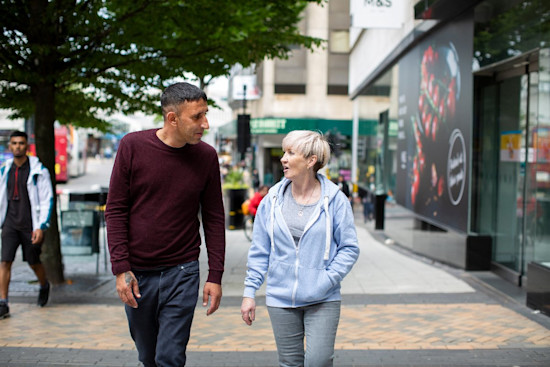 Paddy and Collette walking down the street chatting